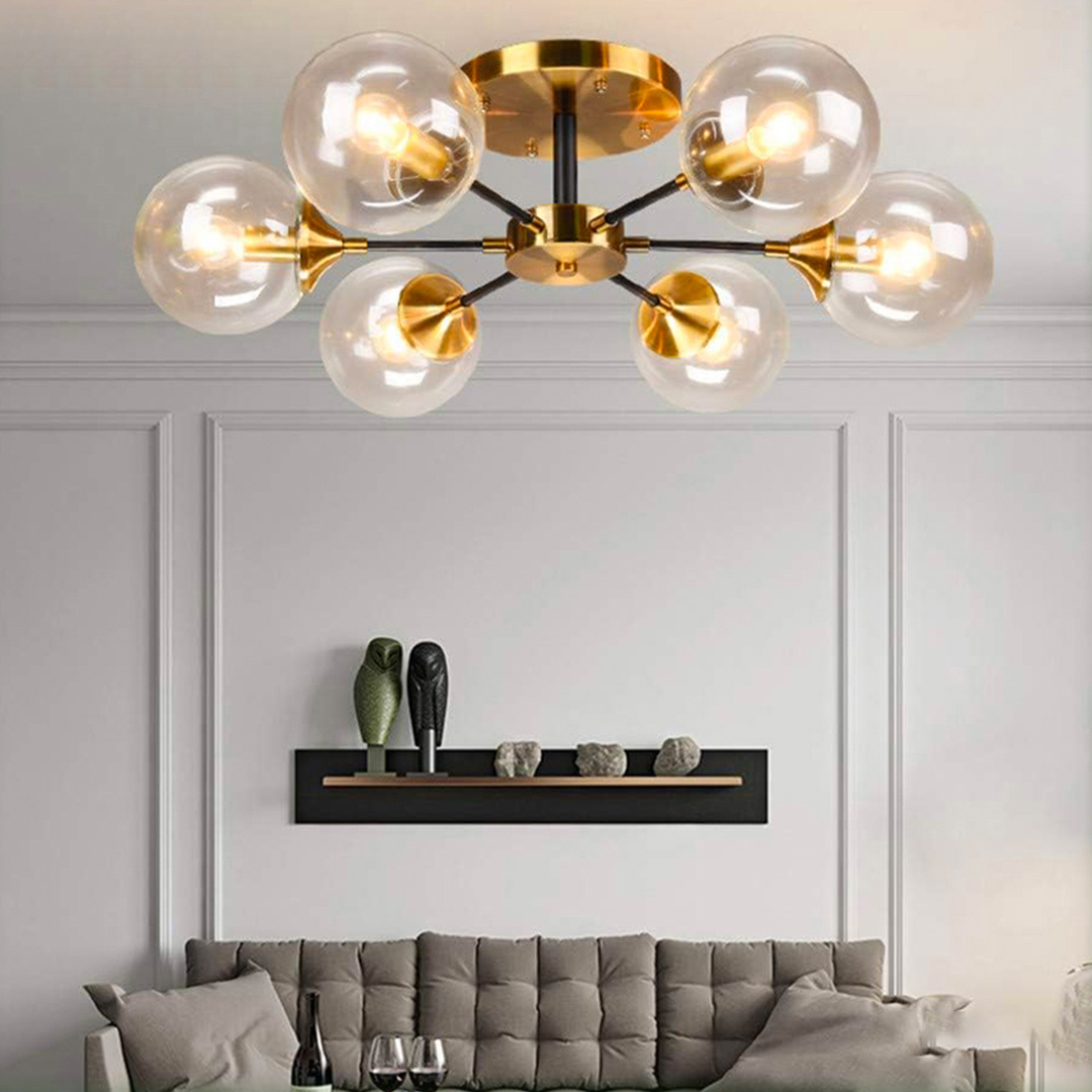 KCO Lighting modern gold 6-light sputnik chandelier with clear glass globe shades. 