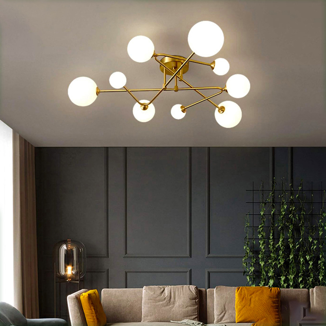 Sputnik-style ceiling light, featuring 8 lights with gold arms and opal glass globes