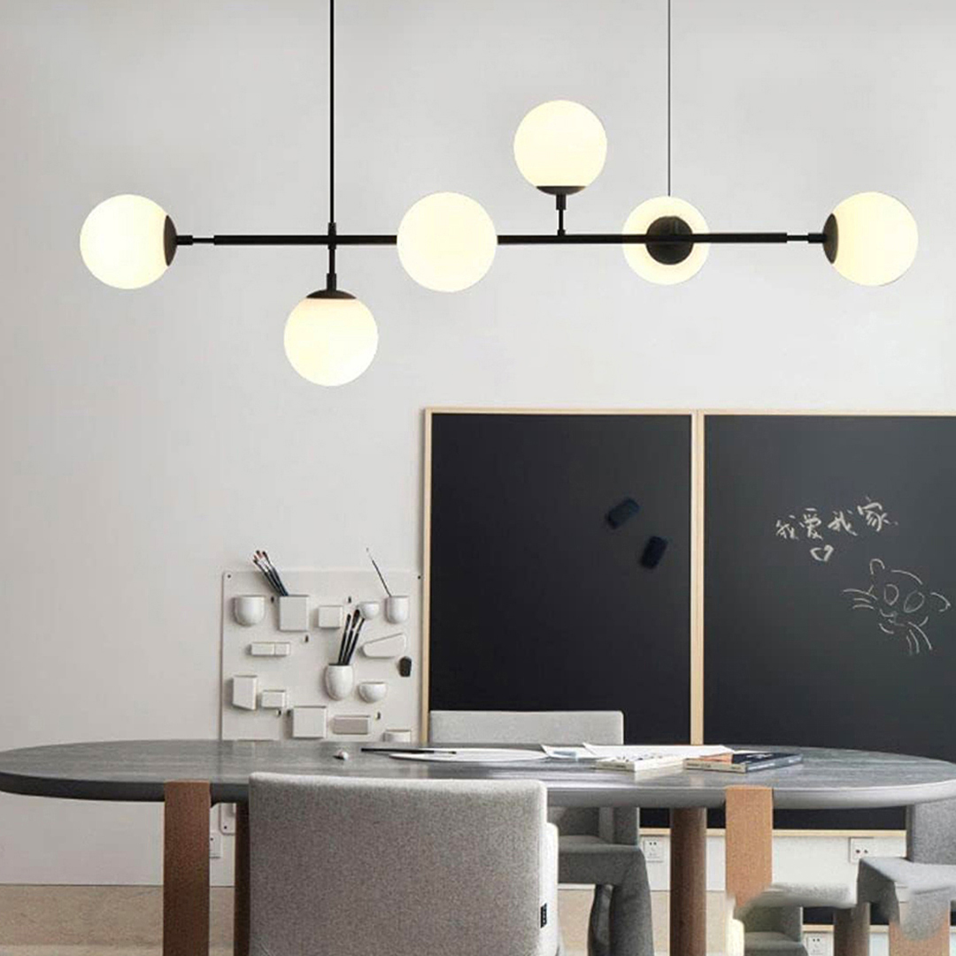 6-light linear chandelier with a black frame and white glass globes, similar to the Madison Black or Dione models
