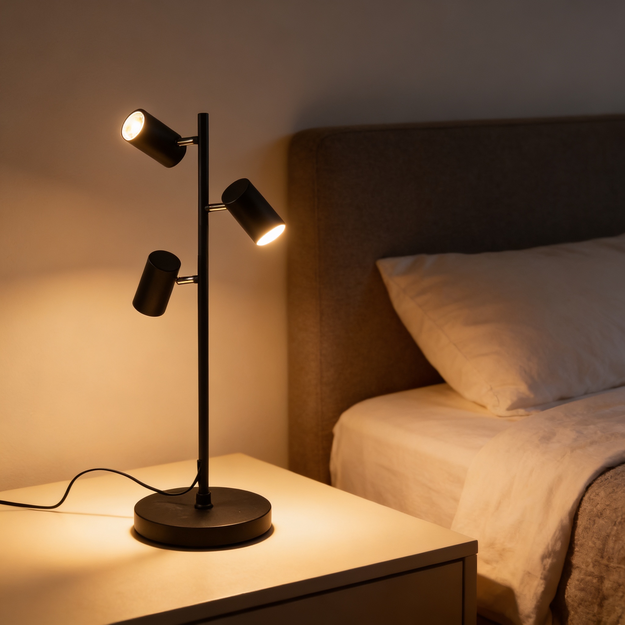 Alternative view of CB2 Trio Matte Black Floor Lamp featuring adjustable shades and a steel base.