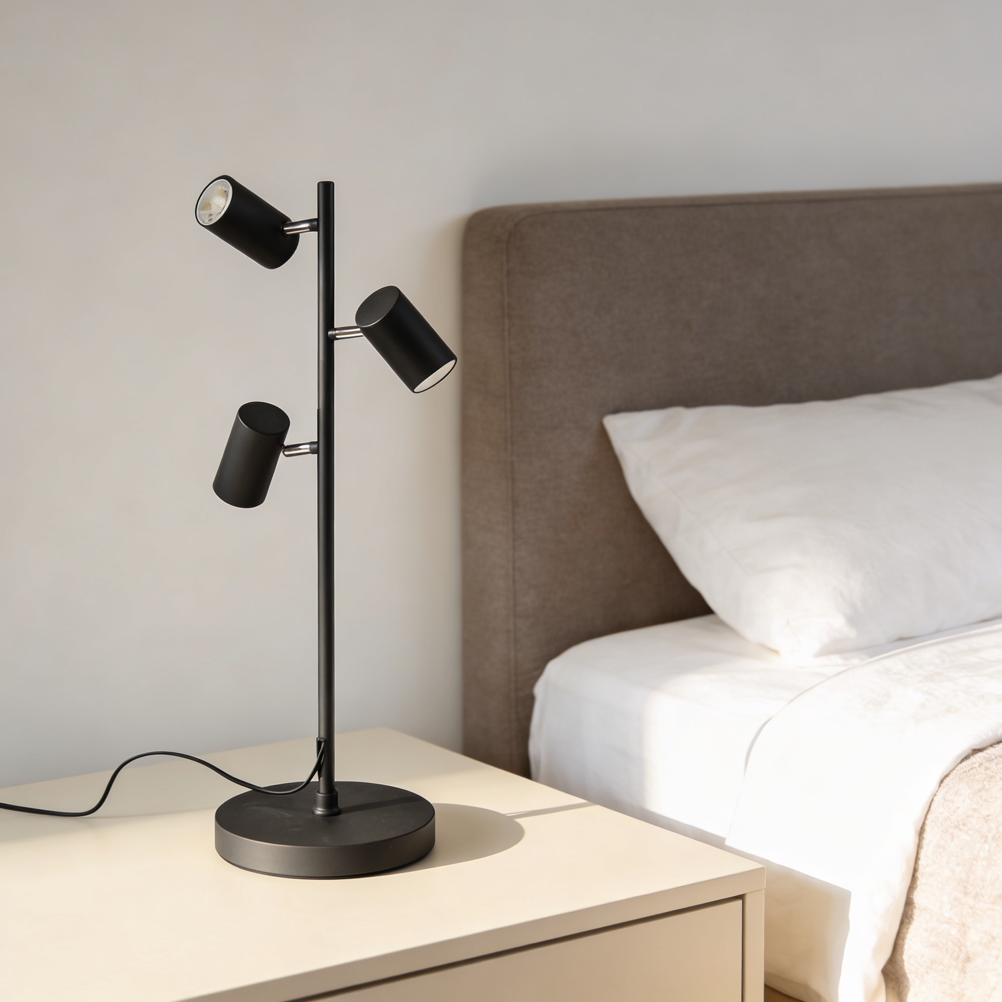 CB2 Trio Matte Black Floor Lamp featuring adjustable shades and a steel base.