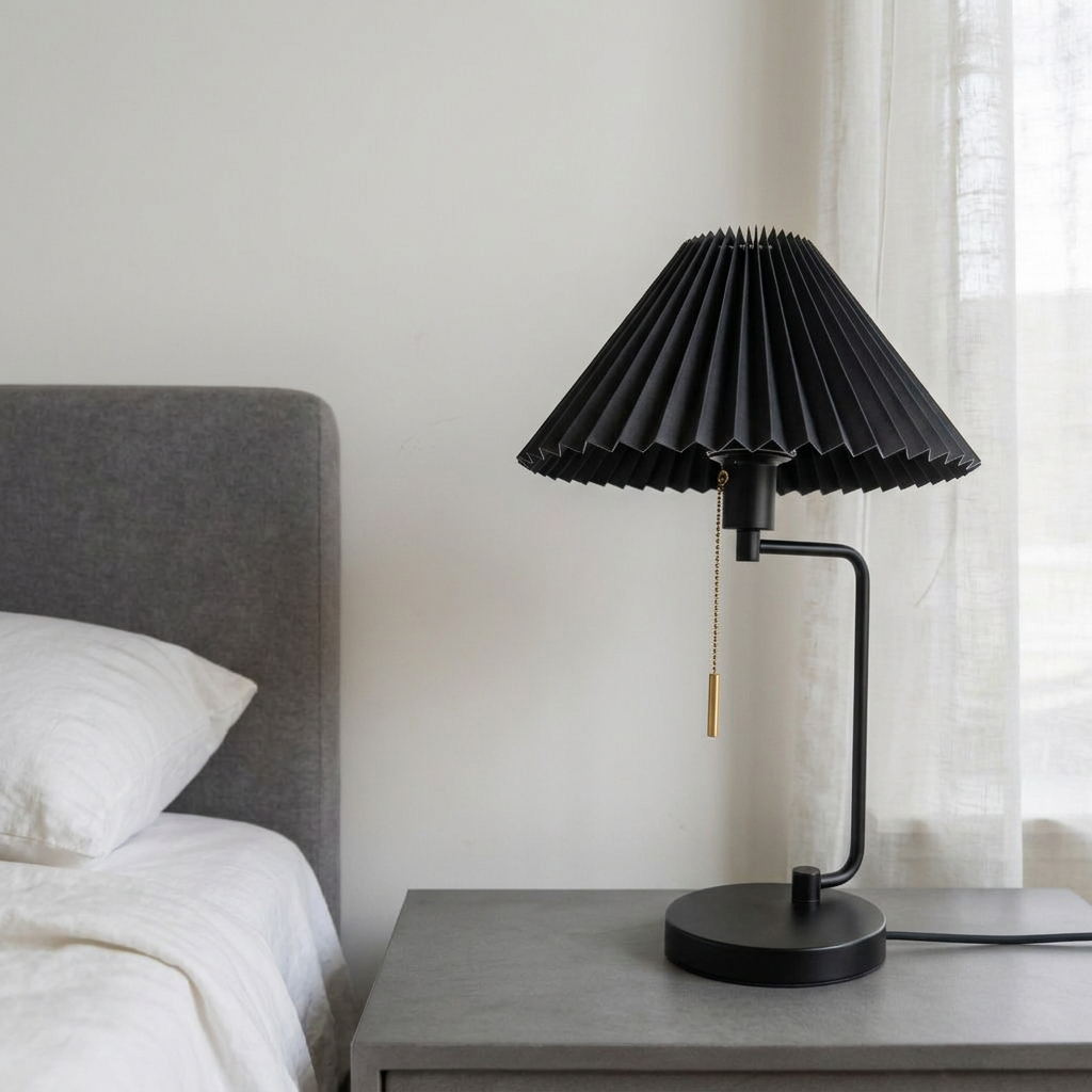 HAY Matin Table Lamp featuring a black pleated shade and a slender black metal base